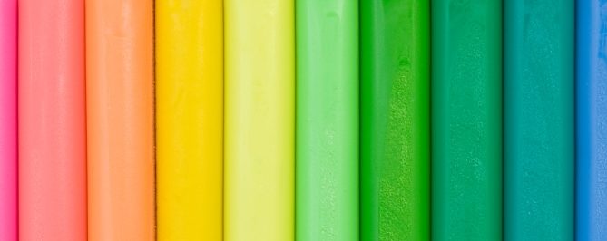 A row of colored poles, running from orange on the left to violet on the right