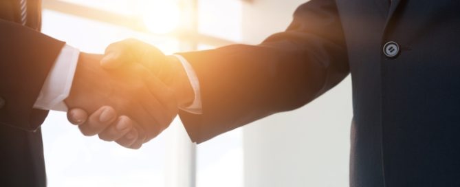 two business professionals shaking hands